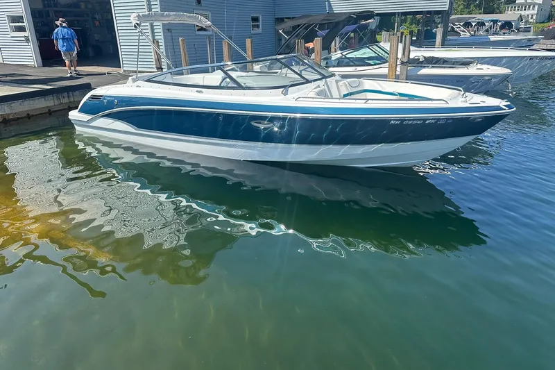 The Image of 2009 Formula 270 Bowrider boat docked in marina, reflecting on calm water. - 0