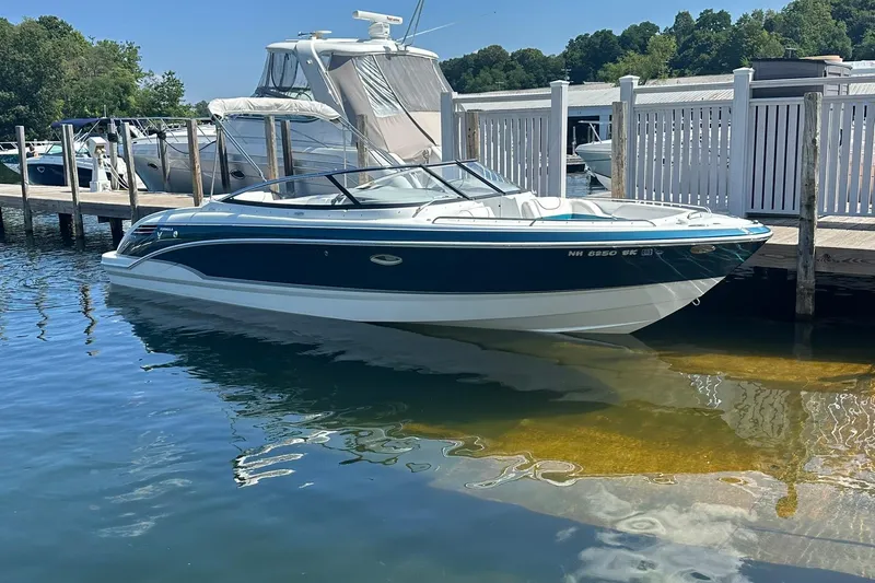 Slide: The Image of 2009 Formula 270 Bowrider docked at marina, clear water, sunny day. - 1