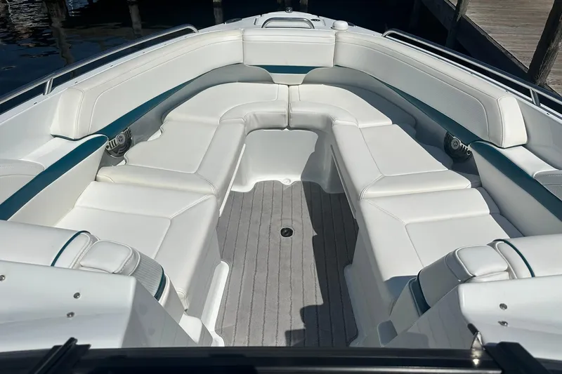 Slide: The Image of 2009 Formula 270 Bowrider boat with spacious white seating and sleek design. - 12