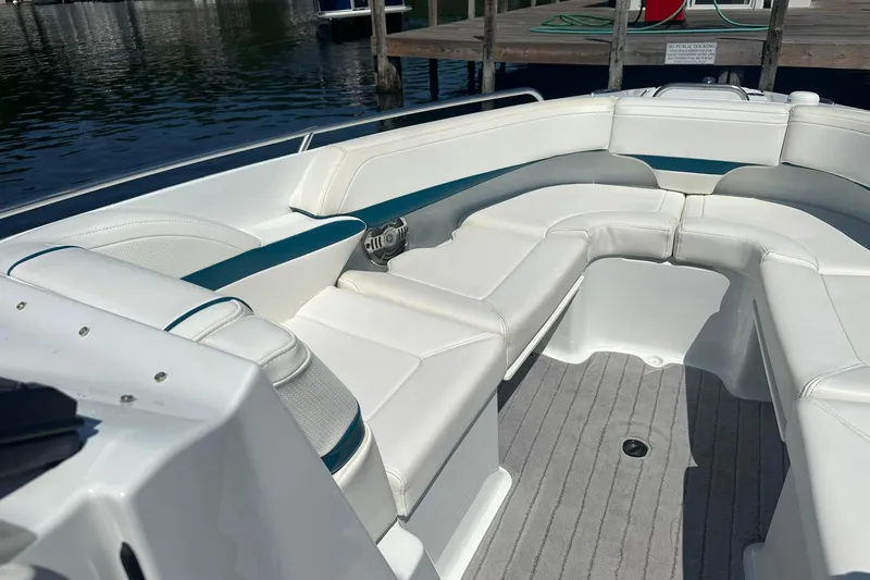 Slide: The Image of 2009 Formula 270 Bowrider boat with white seating and gray flooring at a dock. - 13