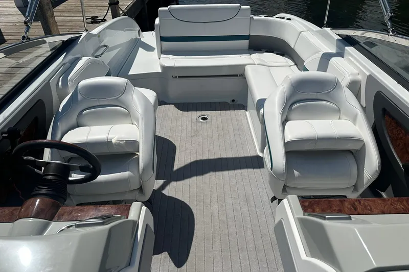 Slide: The Image of 2009 Formula 270 Bowrider interior with white seating and steering wheel, docked by water. - 17