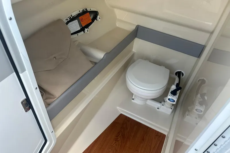 Slide: The Image of 2009 Formula 270 Bowrider boat interior with toilet and storage compartment. - 24