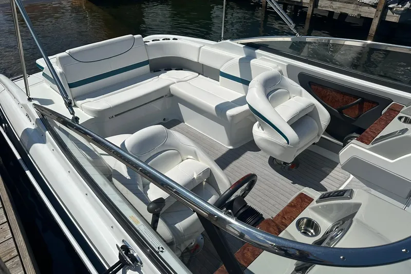 Slide: The Image of 2009 Formula 270 Bowrider boat interior with white seating and wood accents. - 5