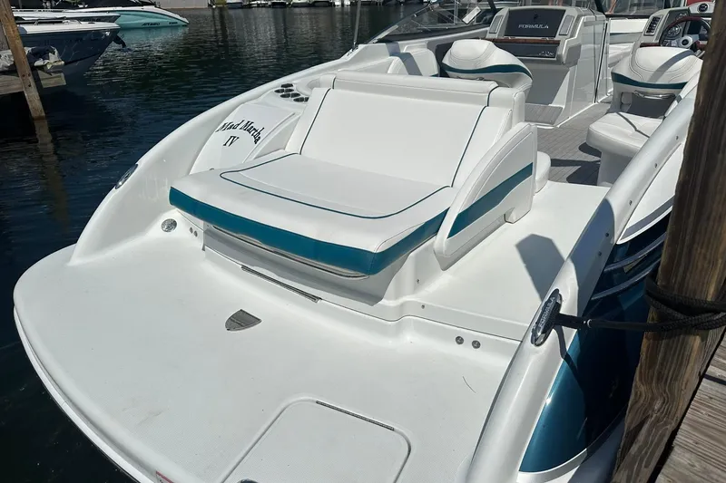 Slide: The Image of 2009 Formula 270 Bowrider boat docked, featuring spacious seating and sleek design. - 6