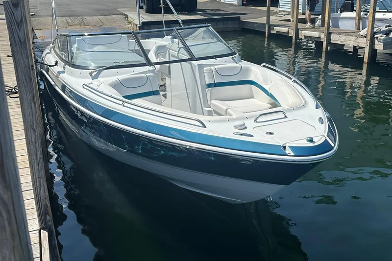 Slide: The Image of 2009 Formula 270 Bowrider boat docked in marina, featuring sleek design and spacious seating. - 7