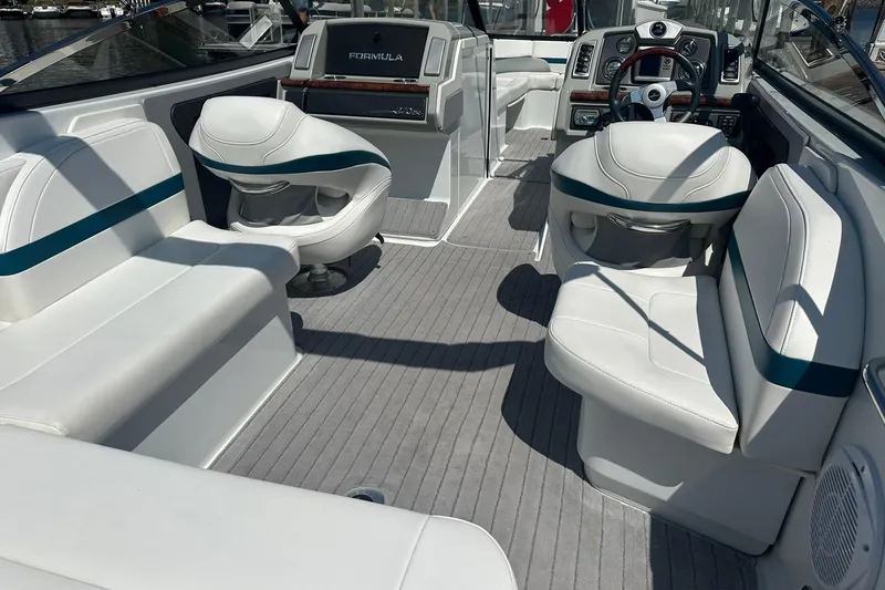 Slide: The Image of 2009 Formula 270 Bowrider interior with white seating and modern dashboard. - 8