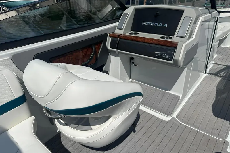 Slide: The Image of 2009 Formula 270 Bowrider interior with white seating and sleek dashboard design. - 9