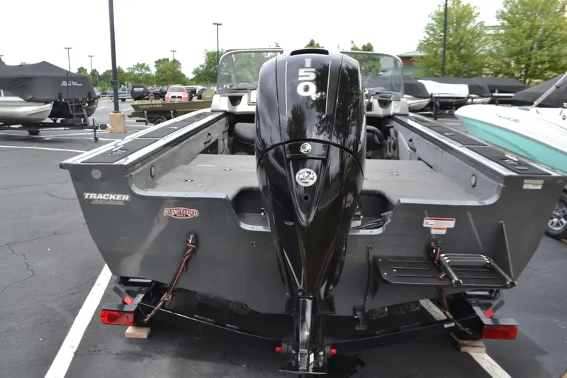 Slide: The Image of 2016 Tracker Targa 18 Combo boat with powerful outboard motor in parking lot. - 2