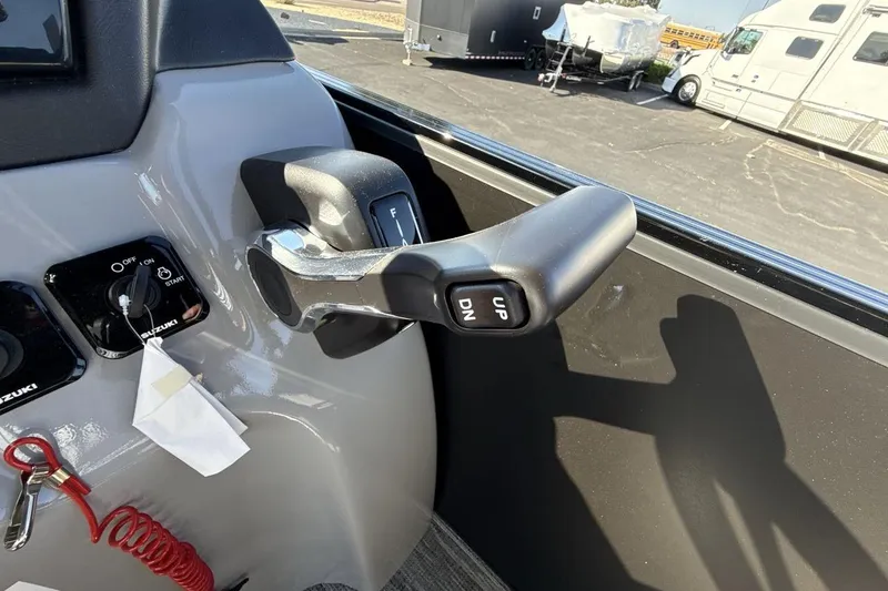 Slide: The Image of Close-up of 2026 Landau Island Breeze 232 Sport Cruise throttle control and ignition. - 16