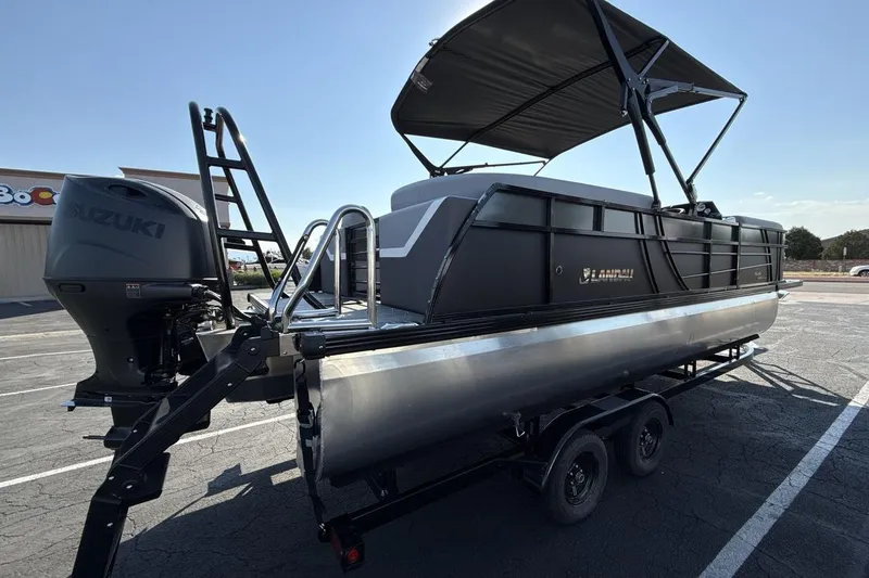 Slide: The Image of 2026 Landau Island Breeze 232 Sport Cruise pontoon boat with Suzuki engine on trailer. - 5