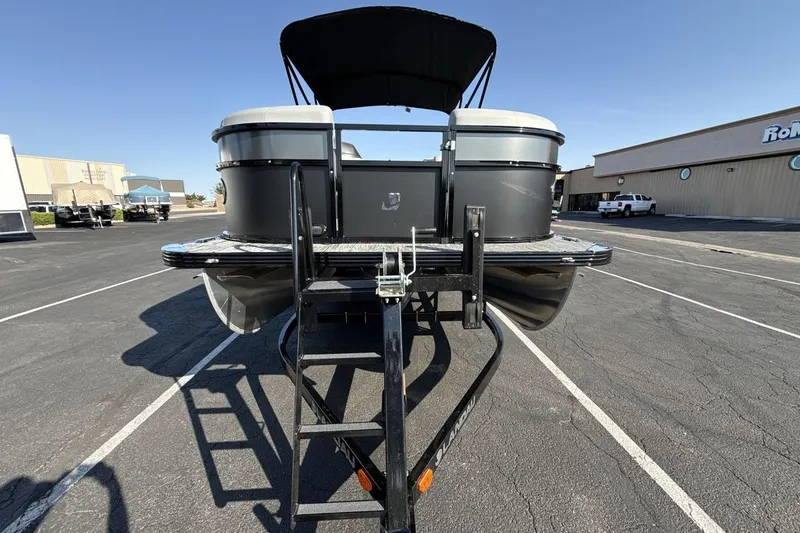 Slide: The Image of 2026 Landau Island Breeze 232 Sport Cruise pontoon boat on trailer in parking lot. - 8