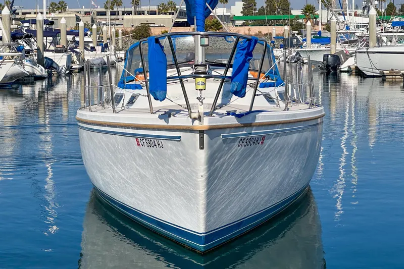 Slide: The Image of 1984 Catalina 30 sailboat docked in a marina, front view. - 15