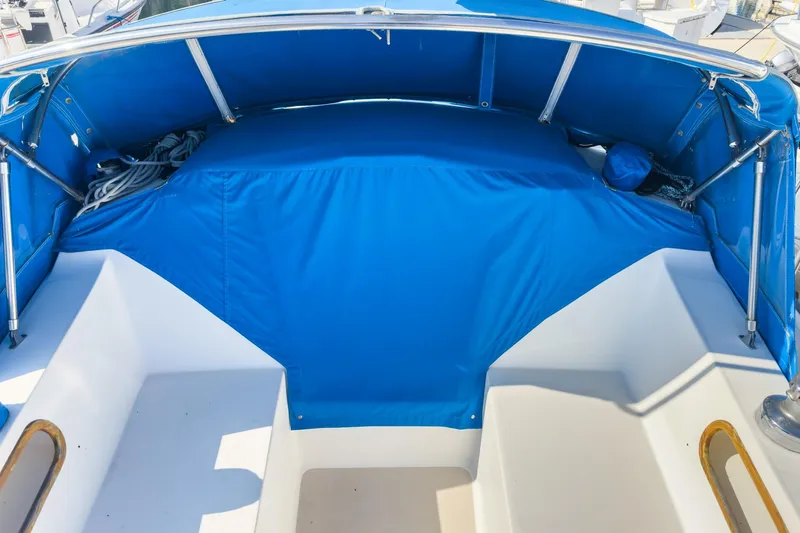 Slide: The Image of 1984 Catalina 30 sailboat cockpit with blue canvas cover and seating area. - 27