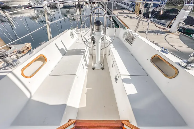 Slide: The Image of 1984 Catalina 30 sailboat cockpit with steering wheel, docked at marina. - 29