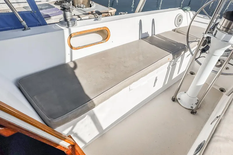 Slide: The Image of 1984 Catalina 30 sailboat cockpit with cushioned seating and steering wheel. - 31