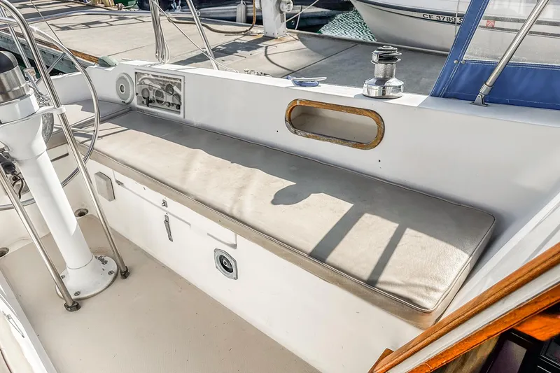 Slide: The Image of 1984 Catalina 30 sailboat cockpit with cushioned seating and steering wheel. - 32