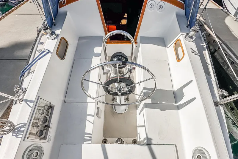 Slide: The Image of 1984 Catalina 30 sailboat cockpit with steering wheel and control panel. - 33