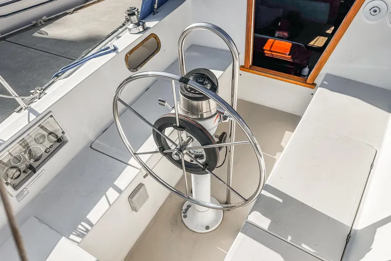 Slide: The Image of Cockpit of a 1984 Catalina 30 sailboat with steering wheel and navigation instruments. - 35