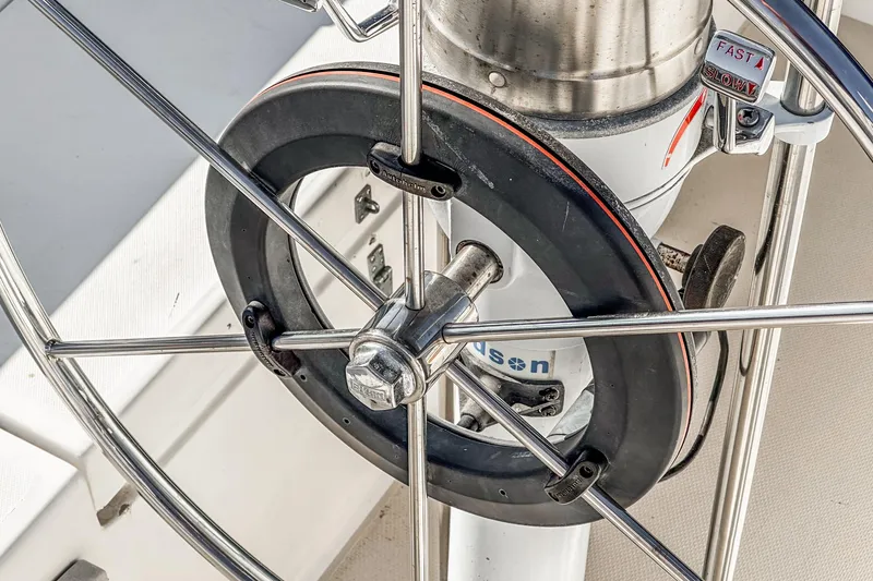Slide: The Image of Close-up of a Catalina 30 sailboat steering wheel, showcasing metal and rubber components. - 36