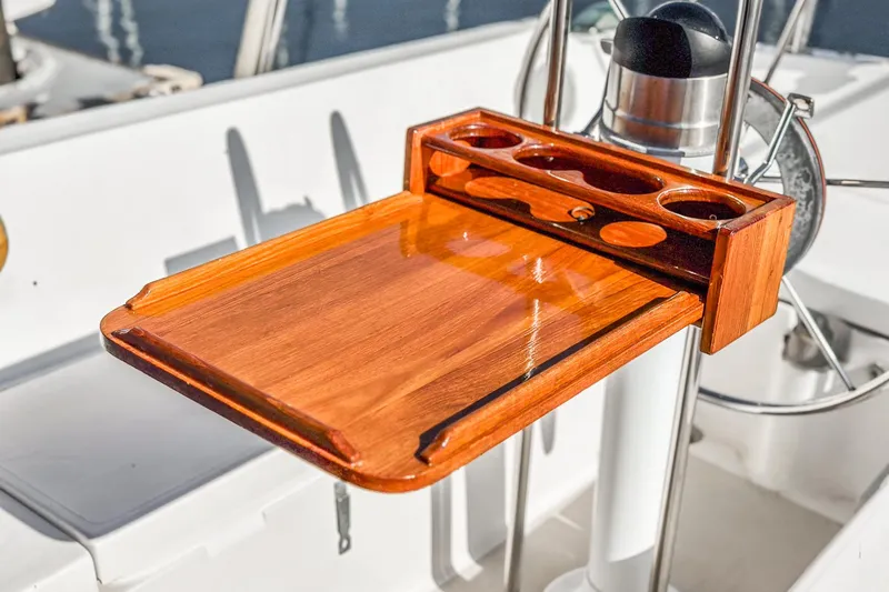 Slide: The Image of Wooden cockpit table on a 1984 Catalina 30 sailboat, featuring cup holders and a polished finish. - 37