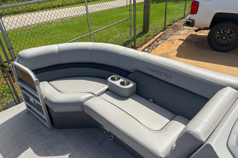 Slide: The Image of 2021 Trifecta 22C CS 2.75 pontoon boat with gray seating and cup holders. - 10