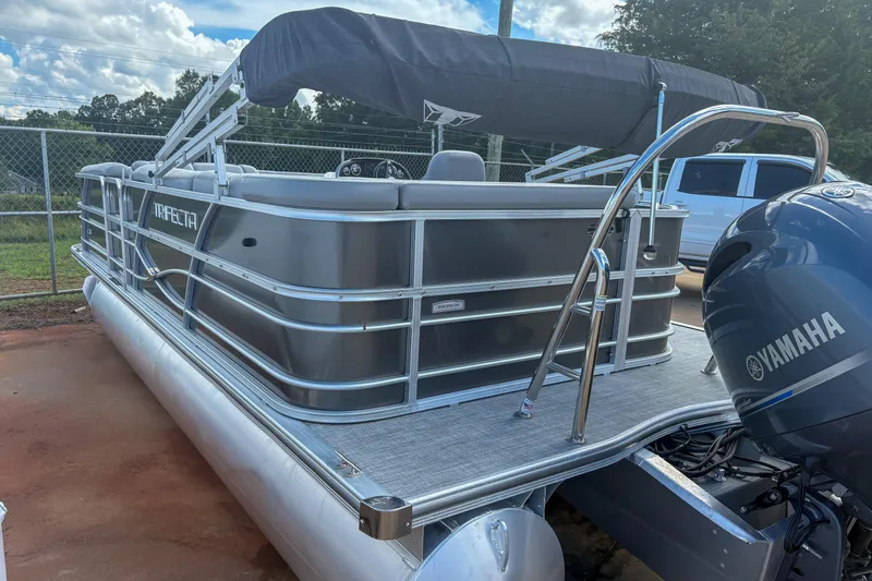 Slide: The Image of 2021 Trifecta 22C CS 2.75 pontoon boat with Yamaha engine, parked outdoors. - 3