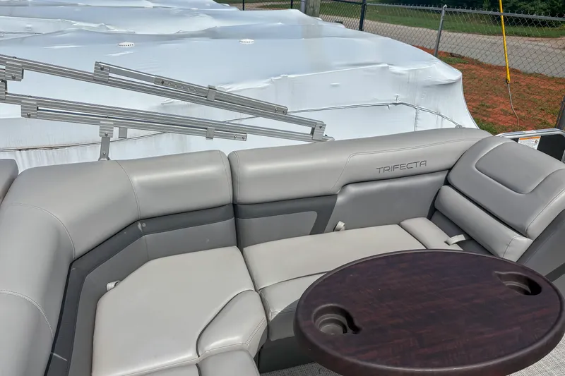 Slide: The Image of Luxurious seating on a 2021 Trifecta 22C CS 2.75 pontoon boat with a wooden table. - 6