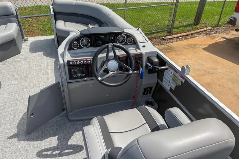 Slide: The Image of 2021 Trifecta 22C CS 2.75 boat interior with steering wheel and seating. - 7