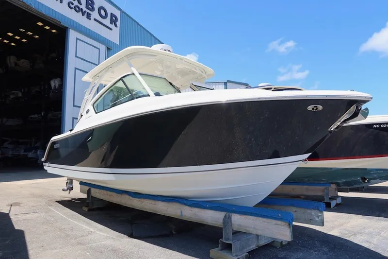 Slide: The Image of 2021 Pursuit DC 266 Dual Console boat on display outside a storage facility. - 32