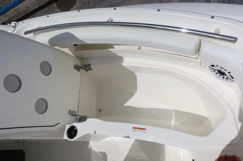 Slide: The Image of 2021 Pursuit DC 266 Dual Console boat interior with open storage compartment. - 37