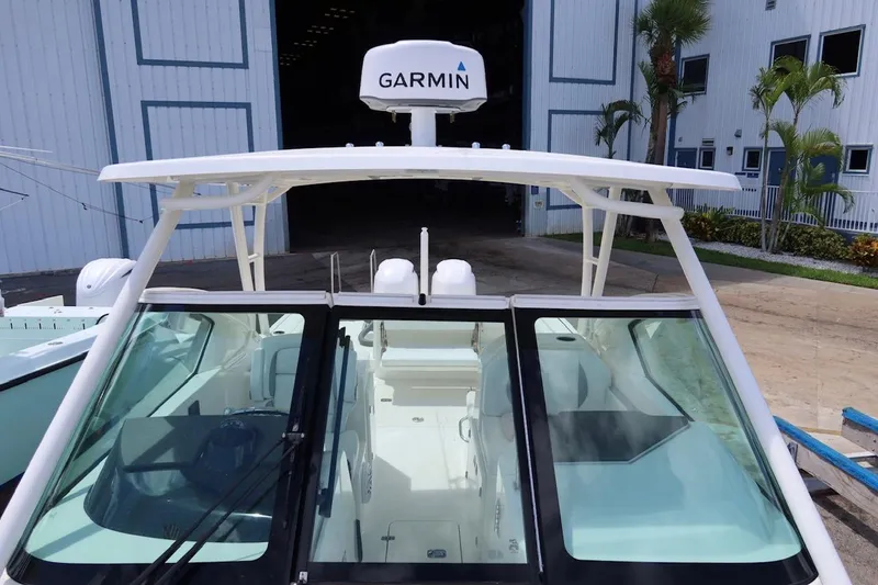 Slide: The Image of 2021 Pursuit DC 266 Dual Console boat with Garmin radar, docked near a warehouse. - 41