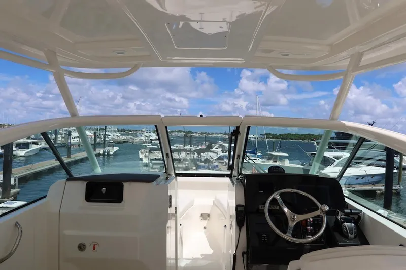 Slide: The Image of 2021 Pursuit DC 266 Dual Console boat interior with marina view. - 43