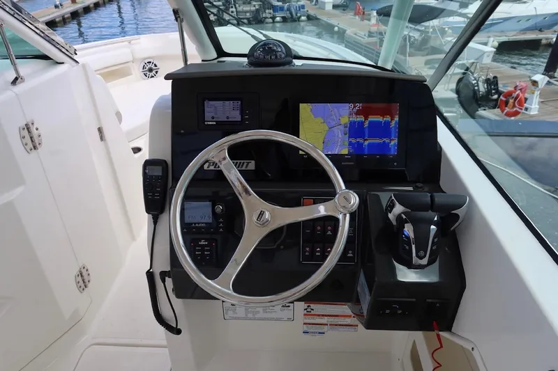 Slide: The Image of 2021 Pursuit DC 266 Dual Console boat dashboard with navigation and control systems. - 44
