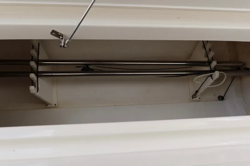 Slide: The Image of 2021 Pursuit DC 266 Dual Console rod storage compartment with secure holders. - 51