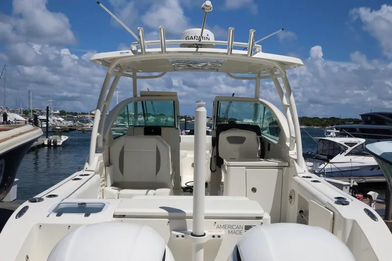 Slide: The Image of 2021 Pursuit DC 266 Dual Console boat docked at marina under blue sky. - 52