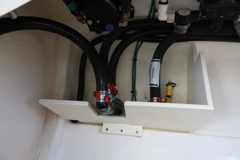 Slide: The Image of 2021 Pursuit DC 266 Dual Console boat plumbing system with hoses and fittings. - 53