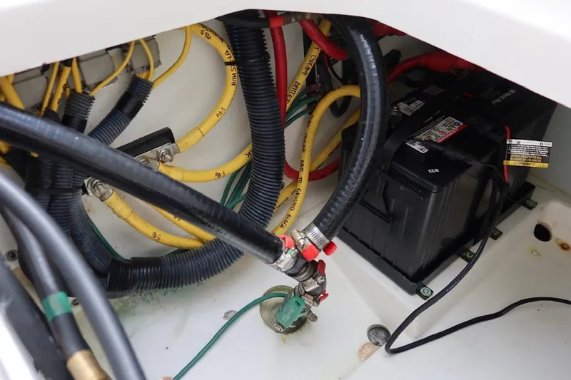 Slide: The Image of 2021 Pursuit DC 266 Dual Console boat wiring and battery compartment. - 55