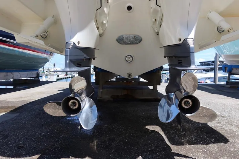 Slide: The Image of 2021 Pursuit DC 266 Dual Console boat with dual propellers in a marina setting. - 62