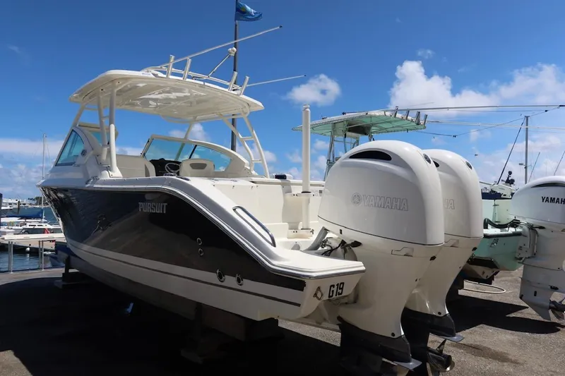 Slide: The Image of 2021 Pursuit DC 266 Dual Console boat with Yamaha engines docked at marina. - 63