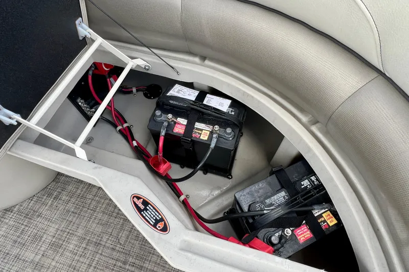 Slide: The Image of 2023 Cypress Cay Seabreeze 232 boat battery compartment with wiring and secure fittings. - 14