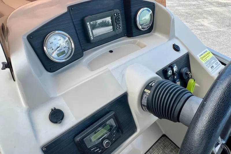 Slide: The Image of 2023 Cypress Cay Seabreeze 232 dashboard with gauges and controls. - 16