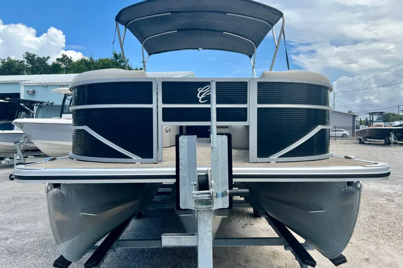 Slide: The Image of 2023 Cypress Cay Seabreeze 232 pontoon boat on trailer, under a cloudy sky. - 3