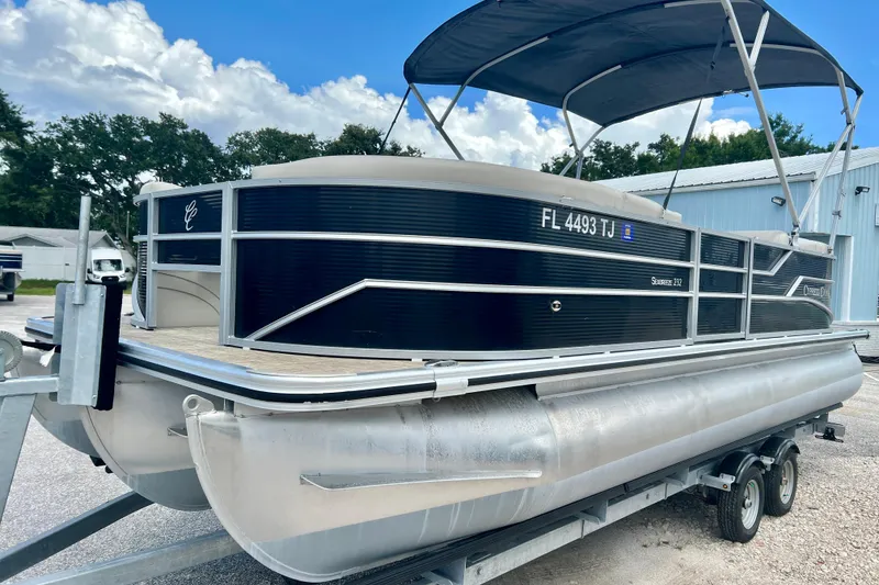 Slide: The Image of 2023 Cypress Cay Seabreeze 232 pontoon boat on trailer, featuring sleek design and canopy. - 4