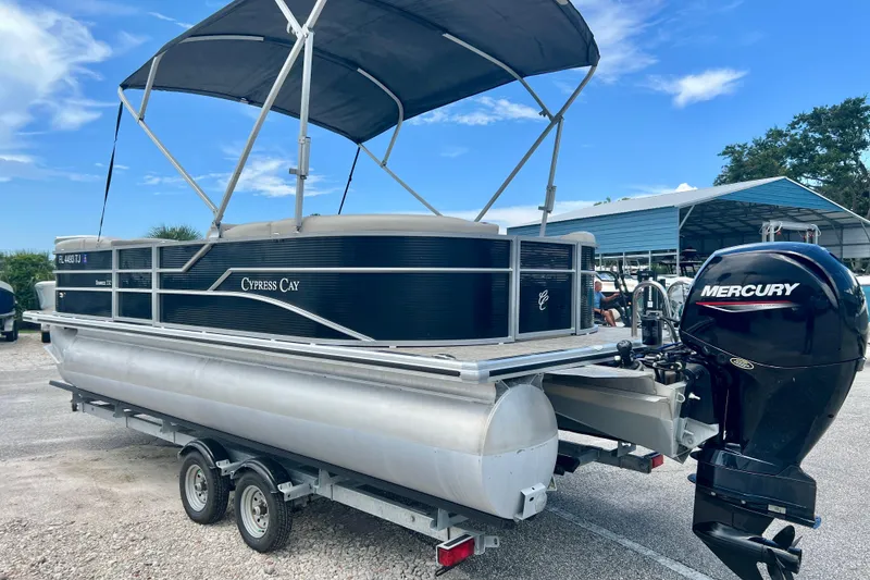 Slide: The Image of 2023 Cypress Cay Seabreeze 232 pontoon boat with Mercury outboard motor on trailer. - 6