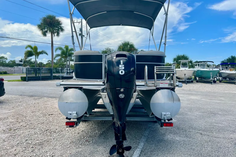 Slide: The Image of 2023 Cypress Cay Seabreeze 232 pontoon boat with 150 HP engine, parked outdoors. - 7