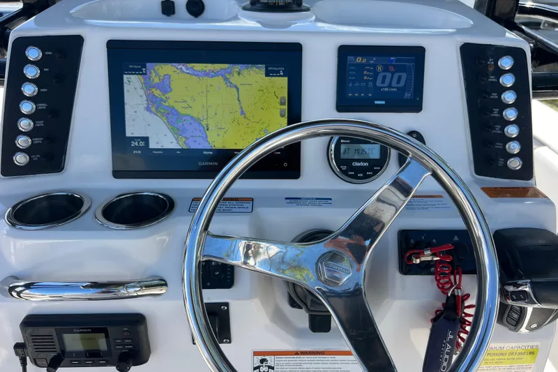 Slide: The Image of 2021 Robalo 246 Cayman SD boat dashboard with Garmin navigation and steering wheel. - 10