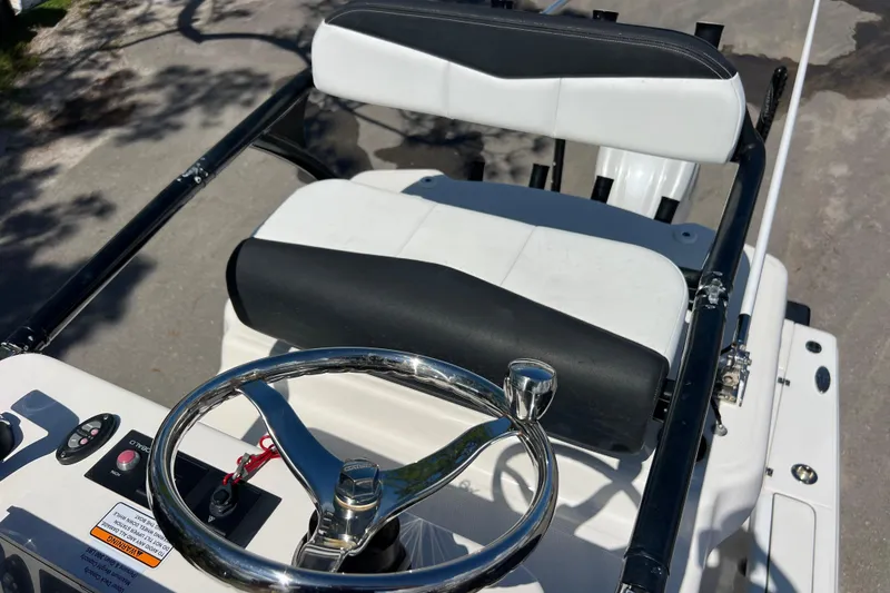 Slide: The Image of 2021 Robalo 246 Cayman SD boat helm with steering wheel and seating. - 18