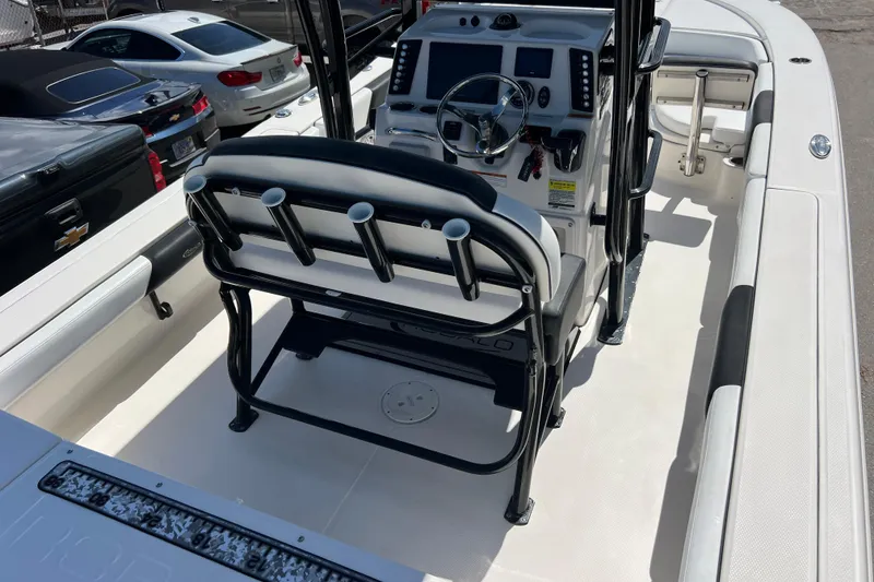 Slide: The Image of 2021 Robalo 246 Cayman SD boat interior with steering console and rod holders. - 7
