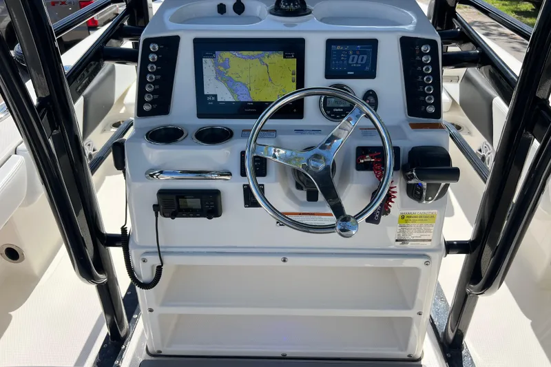 Slide: The Image of 2021 Robalo 246 Cayman SD boat console with steering wheel and navigation display. - 9
