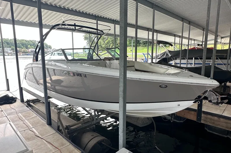 Slide: The Image of 2015 Cobalt R7 boat docked under a covered marina. - 1